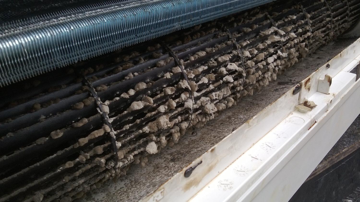 Dirty outdoor heat pump coils with heavy buildup